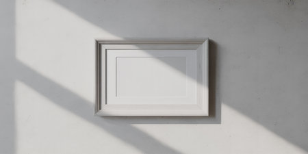 White picture frame on white wall with shadow. 3d rendering.の素材
