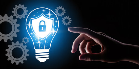 Close up of human hand touching with finger glowing light bulb with padlockの素材