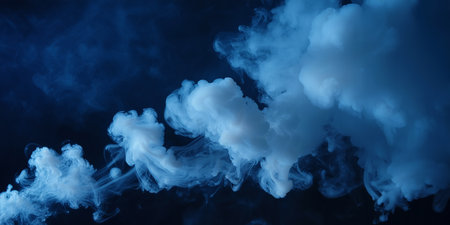 Blue and white cloud of steam on a black background. Copy space.の素材