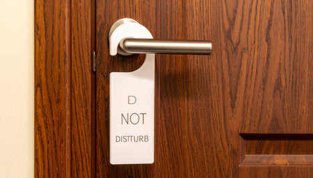 Do not disturb sign on a door handle. Hotel service concept.の素材