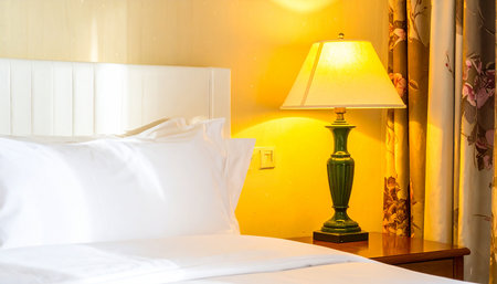 White pillow on bed and light lamp decoration in bedroom interior - Vintage Light Filterの素材