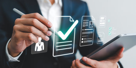 Businessman holding tablet with check mark and checklist icon, business conceptの素材