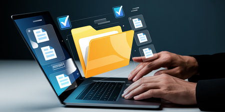 Businesswoman hand typing on laptop with folder icon and copy space aroundの素材