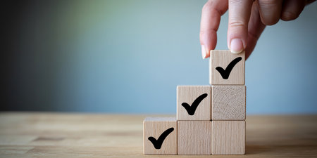 Hand of businesswoman arranging wooden cube with check mark icon on topの素材
