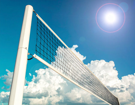 volleyball net on blue sky with sun and lens flare effectの素材