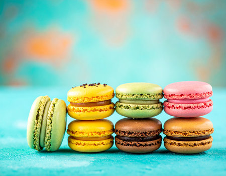 Colorful macaroons on a blue background. Toned.の素材