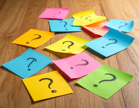 Question mark on colorful sticky notes on wooden background. Question mark conceptの素材