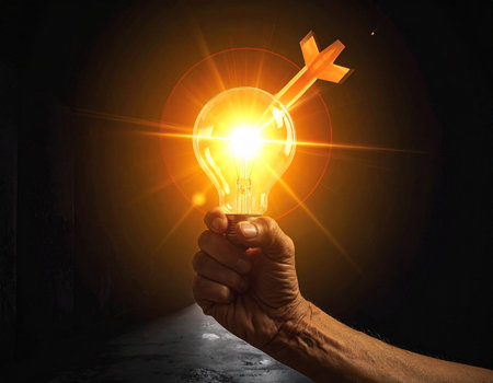 Close up of human hand holding light bulb on dark background. Idea conceptの素材