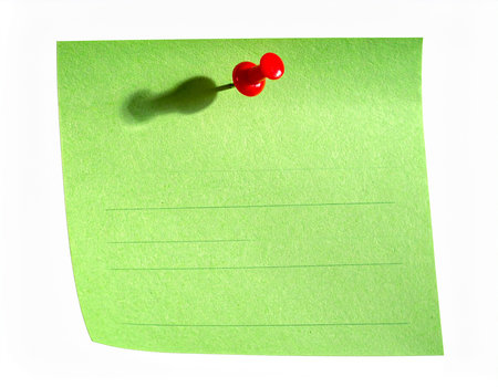 close up of a note paper with a red pushpin on itの素材