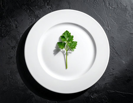 Plate with fresh parsley on black table, top view. Space for textの素材
