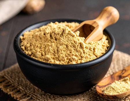 Ginger powder in a bowl on a wooden background. Selective focus.の素材