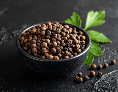 Black pepper in a bowl on a black background. Selective focus.の素材