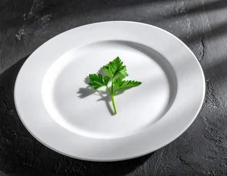 Plate with fresh parsley on dark background, top view. Vegetarian foodの素材