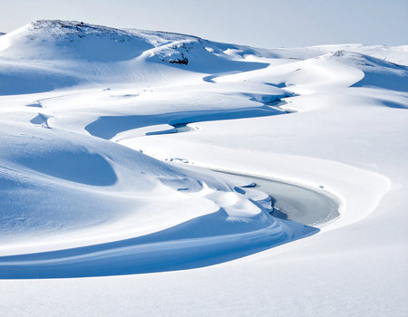 Beautiful winter landscape with snow-capped mountains and blue skyの素材