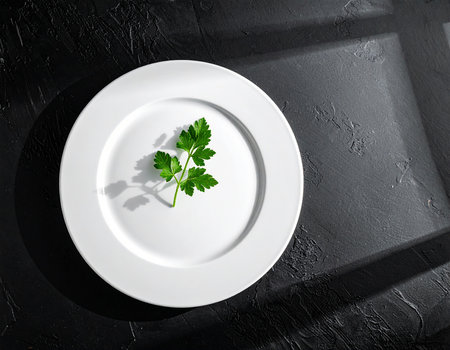 Plate with parsley on black table, top view. Space for textの素材