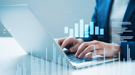 Close up of businesswoman hands typing on laptop keyboard. Virtual screen with business chart and graphs. Online trading concept. Double exposureの素材