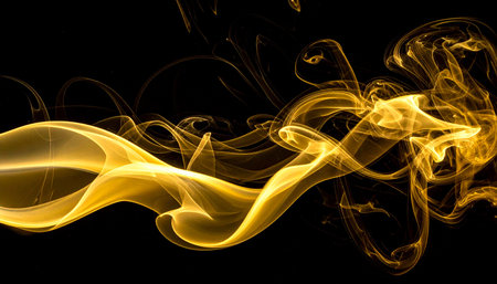 yellow smoke abstract on black background, close-up, studio shotの素材