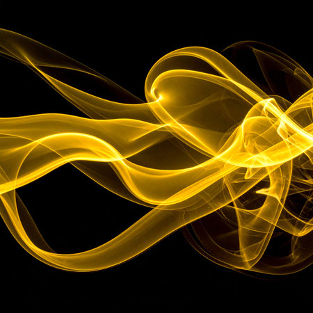 yellow smoke on black background close-up, abstract background for designの素材
