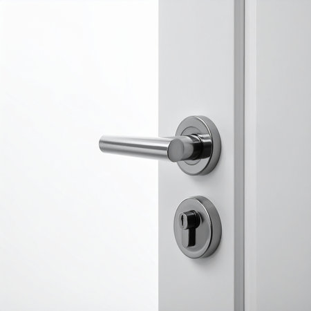Metal door handle on a white door. 3d render illustration.の素材