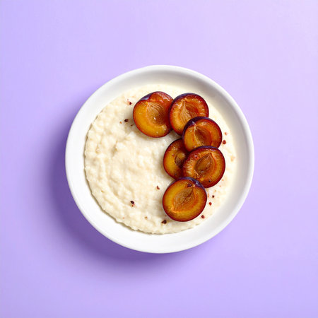 Plum porridge in a bowl on a purple background, top viewの素材