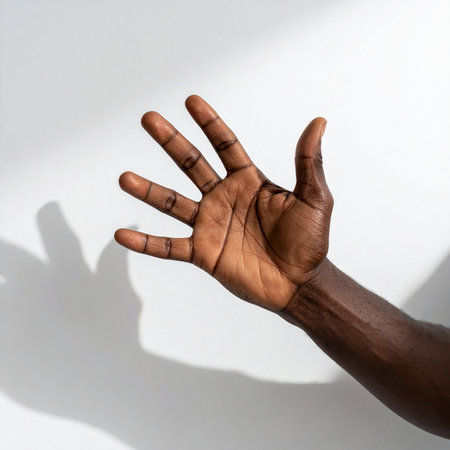 African american man showing stop gesture with shadow on white background.の素材