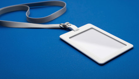 Blank name tag on a blue background. Place for text.の素材