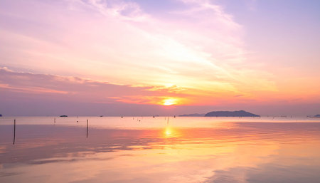 A pastel sky with vibrant sunset colors reflects on the calm ocean surface. Clear details and vibrant colors ...の素材