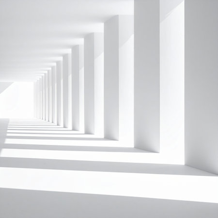 Minimalist white corridor with repeating columns and long shadows creating a sense of depth.の素材
