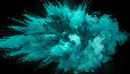 A vibrant teal powder explosion creates a dynamic splash against a dark black background.の素材