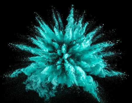 Teal powder bursts outward in a starburst shape, creating a dynamic explosion on black.の素材
