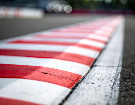 Red and white traffic lines on the road. Shallow depth of field.の素材