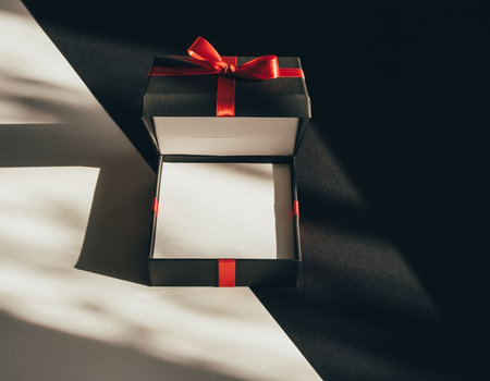 gift box with red ribbon on black and white background, top viewの素材