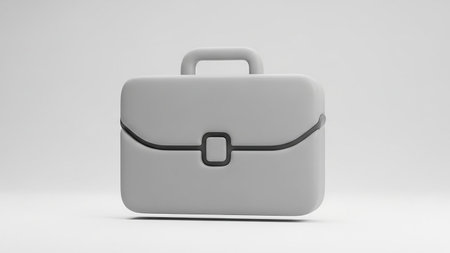 A minimalist 3D gray icon of a briefcase with a handle and clasp, presented on a white background.の素材