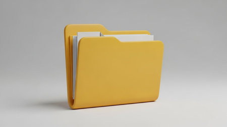 A bright yellow folder is shown open, revealing a stack of white documents inside, placed on a plain gray surface.の素材