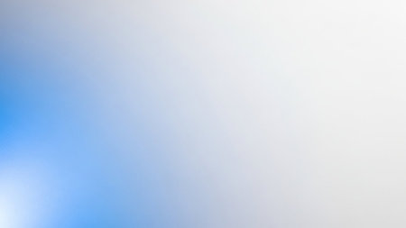 A soft gradient background transitioning from light blue on the left to white on the right, with a subtle light flare, creating a clean and airy feel.の素材