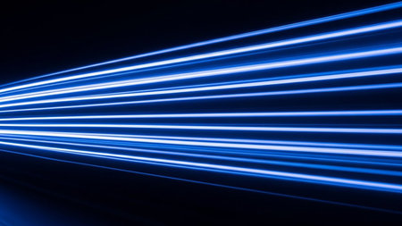 Blue light streaks moving rapidly on a dark background, conveying a sense of speed, technology, and data transfer.の素材
