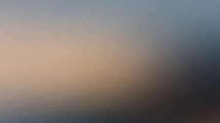 A softly blended gradient background transitions from warm beige tones to cool blue and gray hues with a smooth, diffused effect.の素材