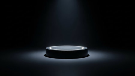 A dark cylindrical stage platform with a white neon light ring around its top edge is illuminated by a spotlight from above.の素材
