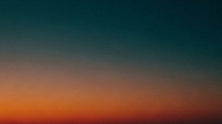 A smooth gradient background transitioning from deep teal at the top to warm orange and red hues at the bottom, resembling a sunset.の素材