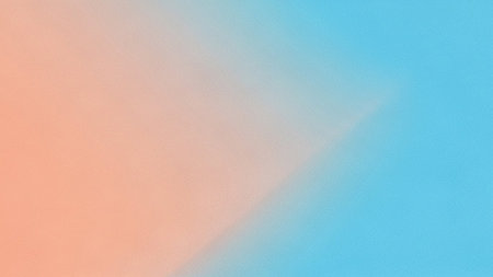 A soft, abstract gradient blends peach and light blue tones with a subtle grainy texture for a gentle aesthetic.の素材