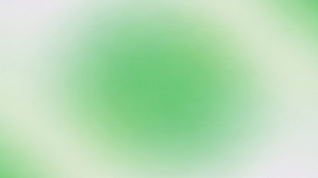A soft focus background with a gentle green and white gradient, featuring a blurred central circle.の素材