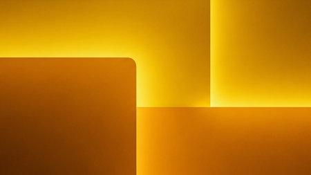 An abstract geometric background in warm golden yellow tones featuring sharp lines and glowing illuminated edges for a modern feel.の素材