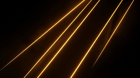 Bright yellow light streaks glow and move diagonally across a dark background. Clear details and vibrant color...の素材