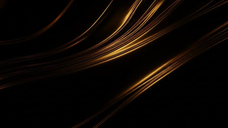 Golden light streaks flowing on a dark black background creating an abstract and dynamic motion effect.の素材