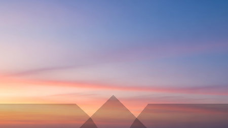 A pastel sunset sky with soft clouds is overlaid with translucent geometric triangles in a clean design.の素材