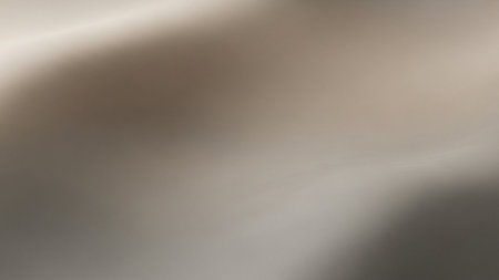 A smooth metallic texture background with subtle ripples and soft lighting in shades of grey.の素材