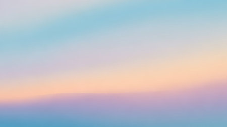 A soft gradient background with blended pastel colors of blue, peach, and purple creating a dreamy atmosphere.の素材