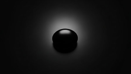 A smooth black sphere casting a shadow in a dark, subtly lit studio setting Clear details and vibrant colors e...の素材