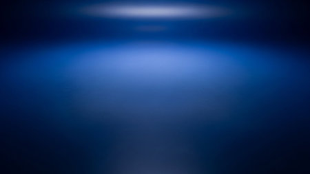 Deep blue gradient background with a soft, luminous spotlight effect at the top. Clear details and vibrant col...の素材