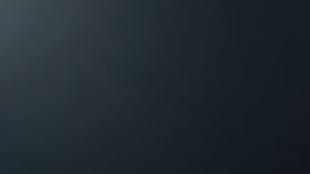 A plain, dark gray textured surface with a subtle gradient and a dark vignette effect around the edges.の素材
